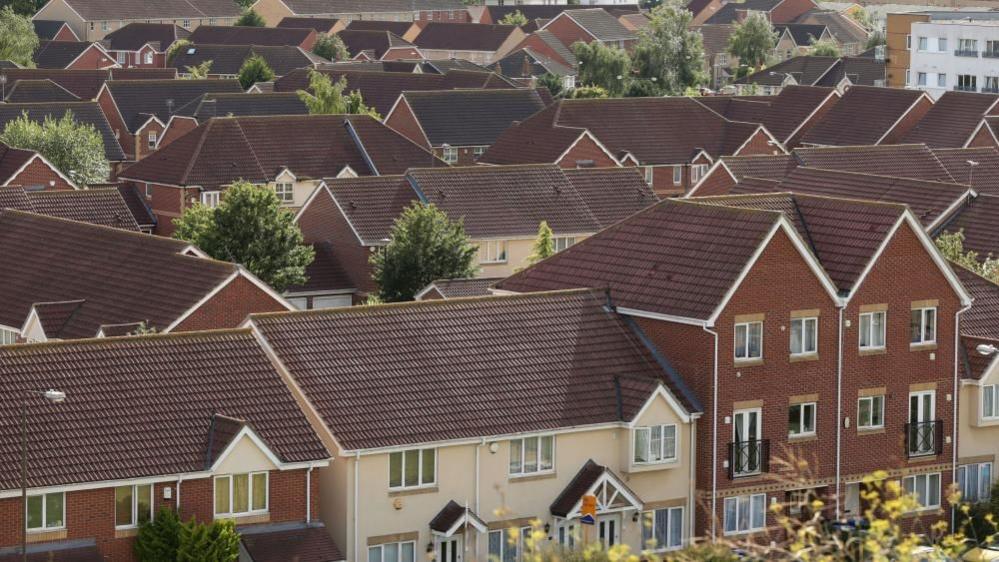 Brown and cream coloured houses in a neighbourhood as seen from above