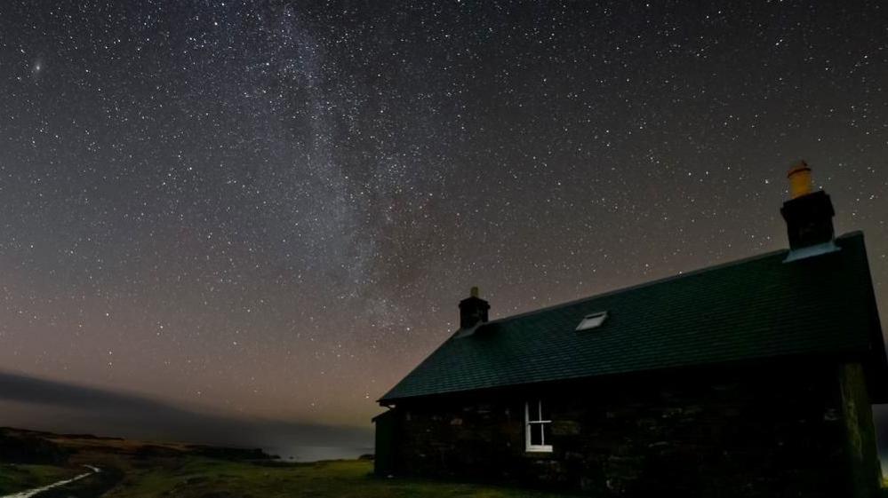 A house on Rum at night with stars in the sky above it