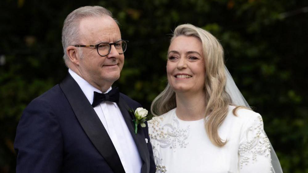 A headshot photo of Anthony Albanese and Jodie Haydon in their wedding attire