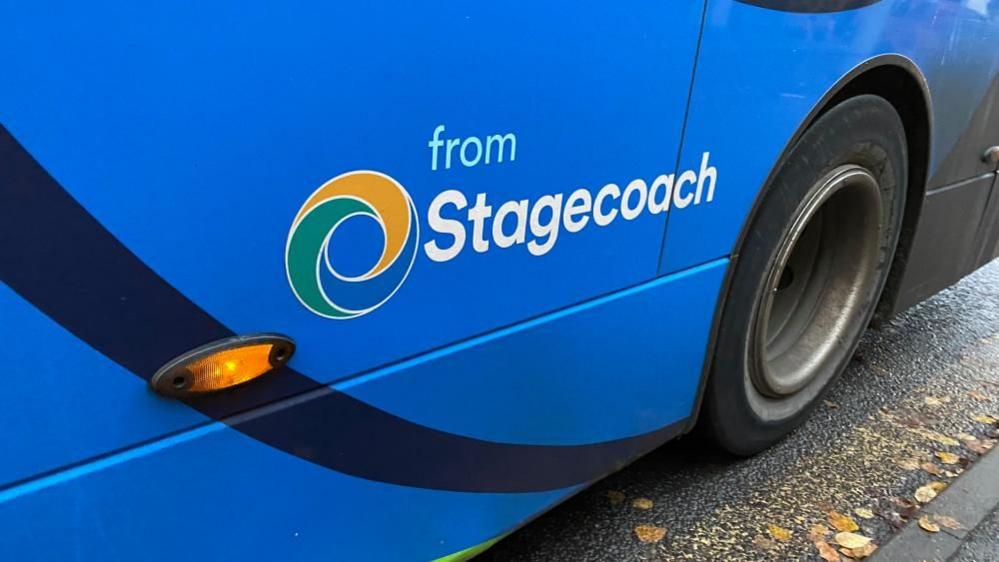 A close up of a blue bus. The words from Stagecoach are written.