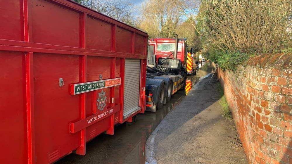 West Midlands fire vehicles in flood water