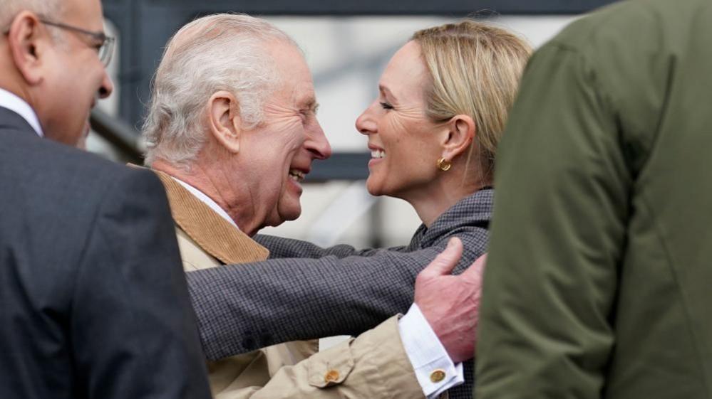 The King embraces his niece Zara Tindall 