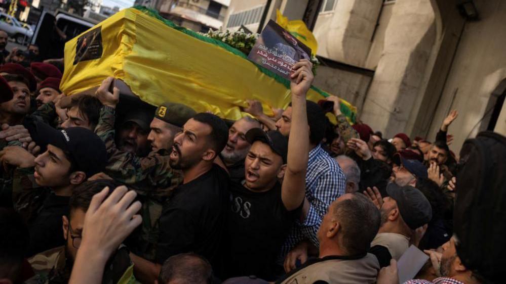 Mourners carry the coffin of Fuad Shukr, a senior Hezbollah commander who was killed in an Israeli strike on Tuesday, during his funeral in Beirut's southern suburbs, Lebanon August 1, 2024.