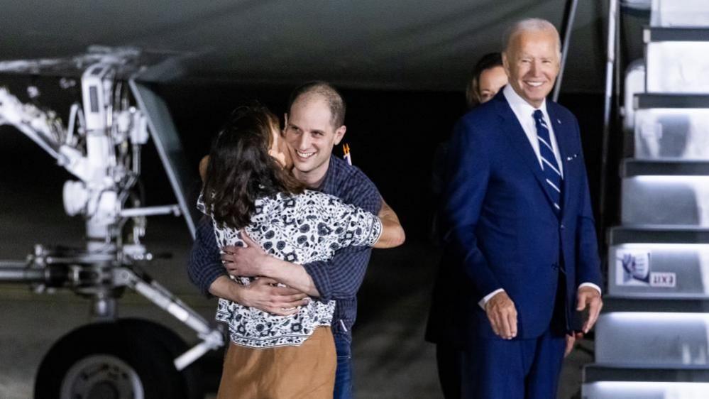 President Joe Biden watches as Wall Street Journal reporter Evan Gershkovich greets his mother after being freed from Russian detention.