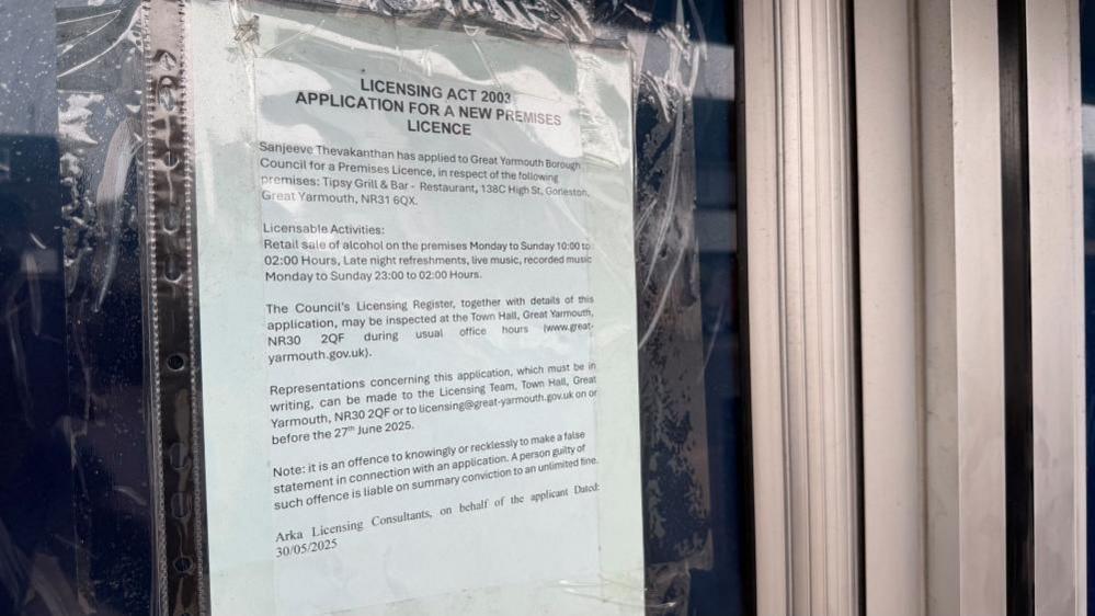 A notice in the window of the former Boots the Chemist window, with aluminium window and door fittings visible.