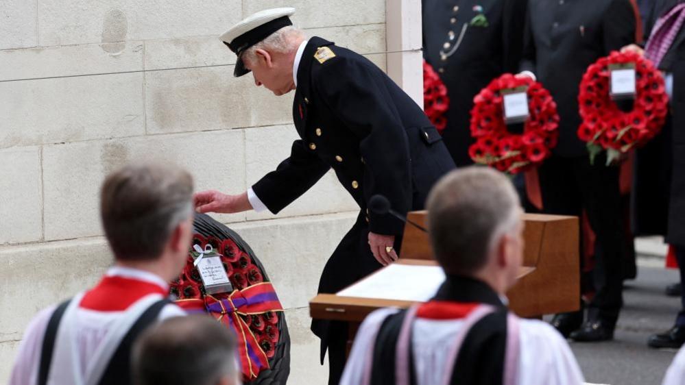 King Charles leans down to place a wreath at the base of the Cenotaph