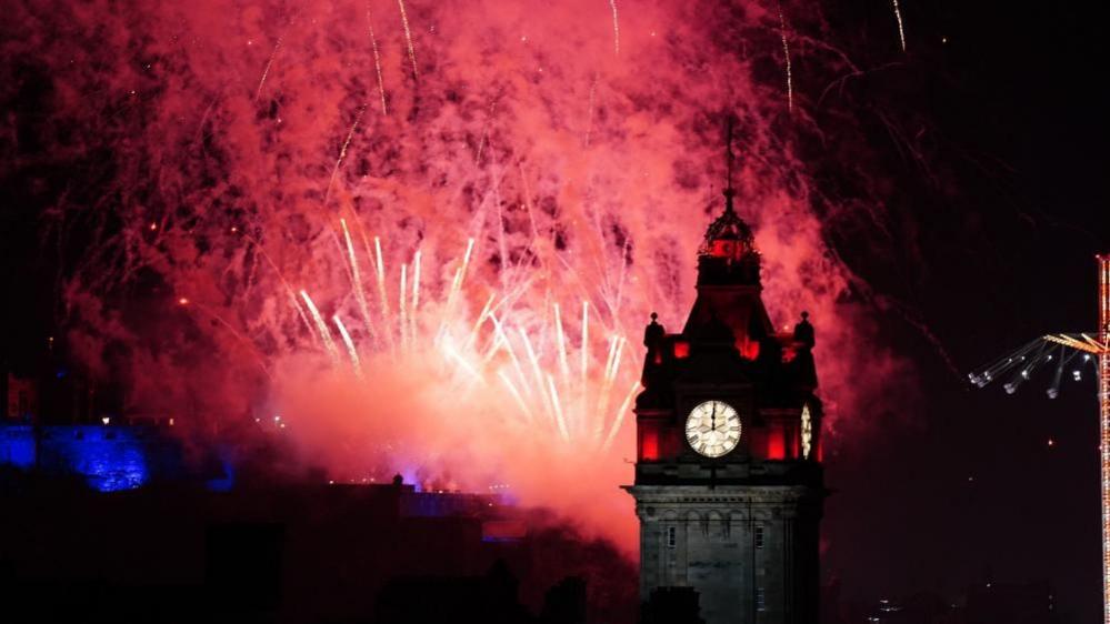 Fireworks explode over Edinburgh Castle during the street party for Hogmanay New Year celebrations in Edinburgh