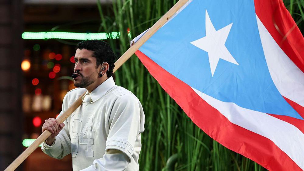 Bad Bunny holding a Puerto Rico flag.