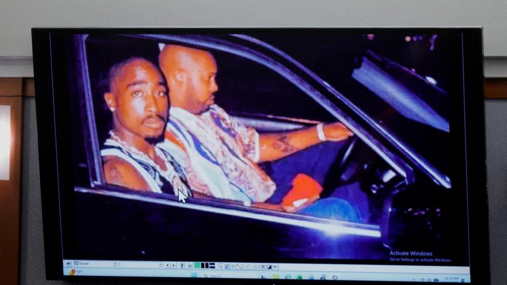 A 1996 photo of rapper Tupac Shakur (L) and Marion "Suge" Knight is displayed during the Duane Davis murder trial.