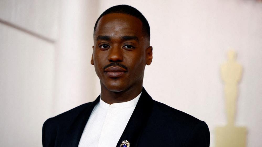 Ncuti Gatwa looks at the camera.