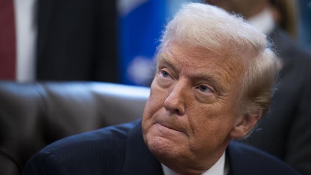 Donald Trump looks to his right with his lips pursed