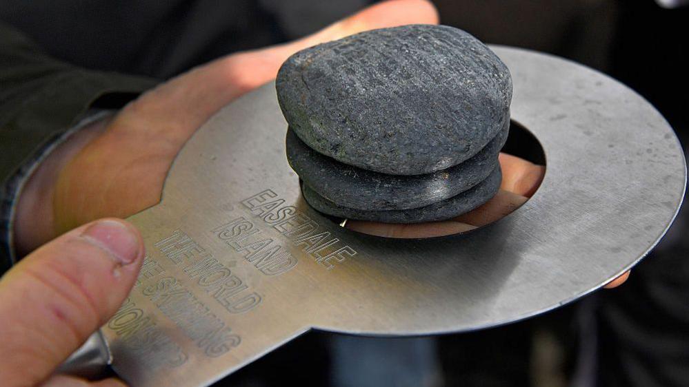 Stones being measured before being skimmed