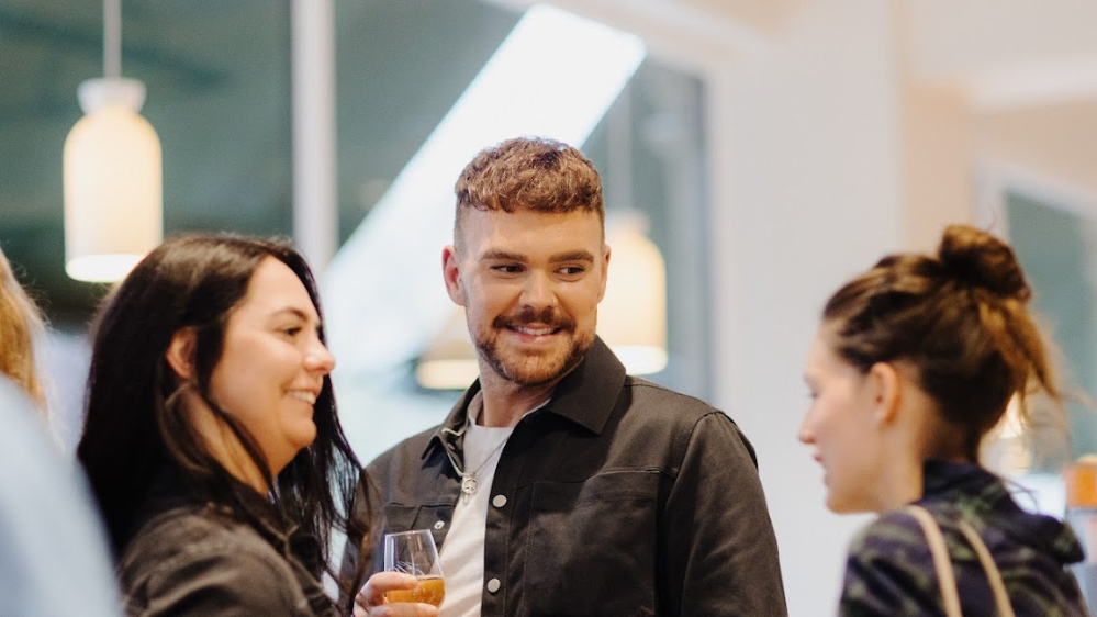 James talks to two women at the event 