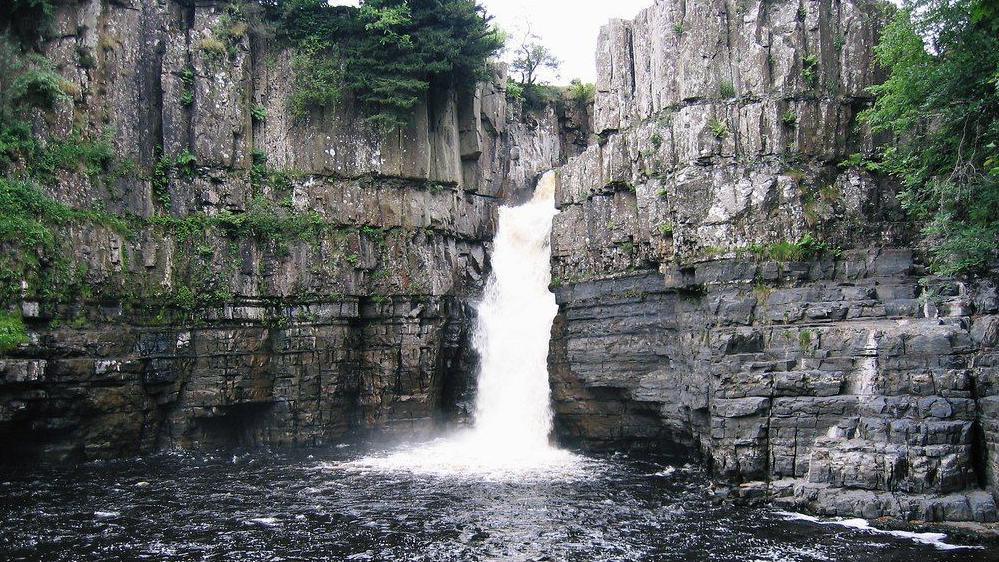 View of High Force waterfall. The river plunges 70ft (21 meters) between two high cliffs and into a pool.