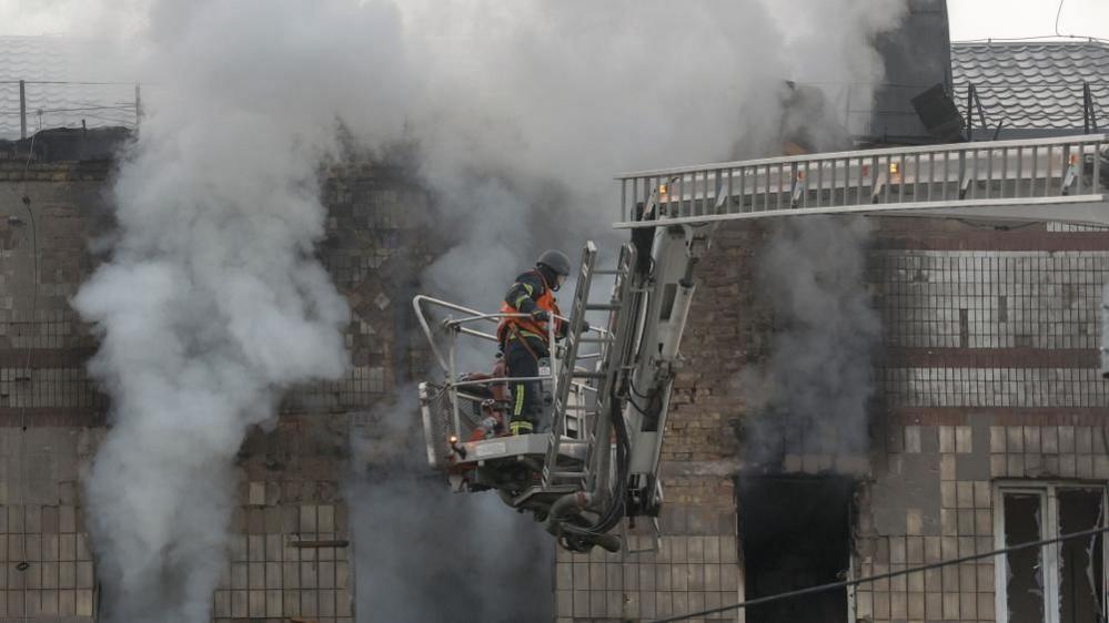 Ukrainian rescuers inspect a residential building in Kyiv, following a Russian drone attack. Photo: 7 May 2025