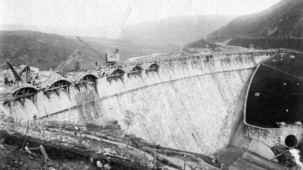 Black and white image depicting the building of the dams