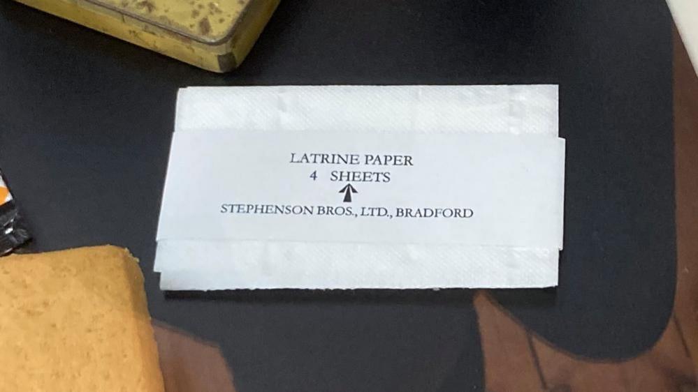 A white envelope labelled "latrine paper - 4 sheets"