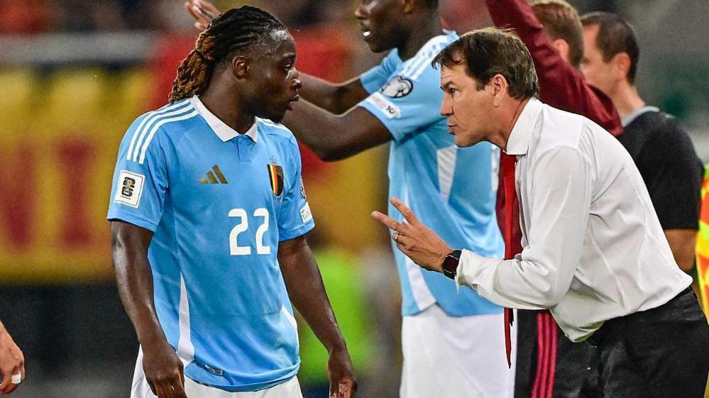 Rudi Garcia offers instructions to Jeremy Doku