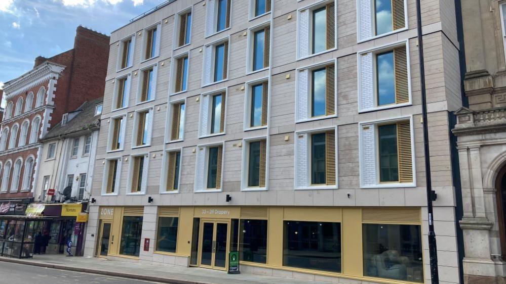 Student flats in Northampton, with a yellow and stone frontage