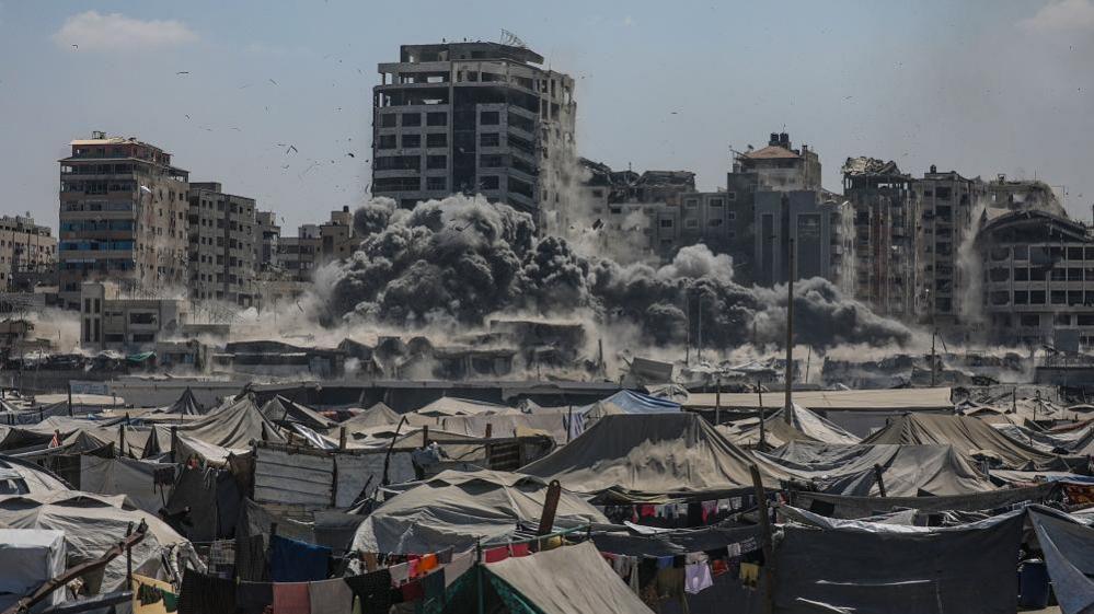 Smoke rises at the Harmony Tower following an Israeli airstrike in the west of Gaza City