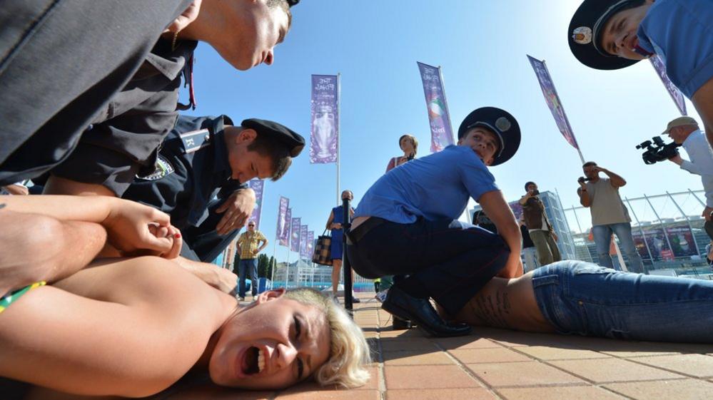 Policemen arrest activists of the Ukrainian women's movement Femen during a protest in Kiev