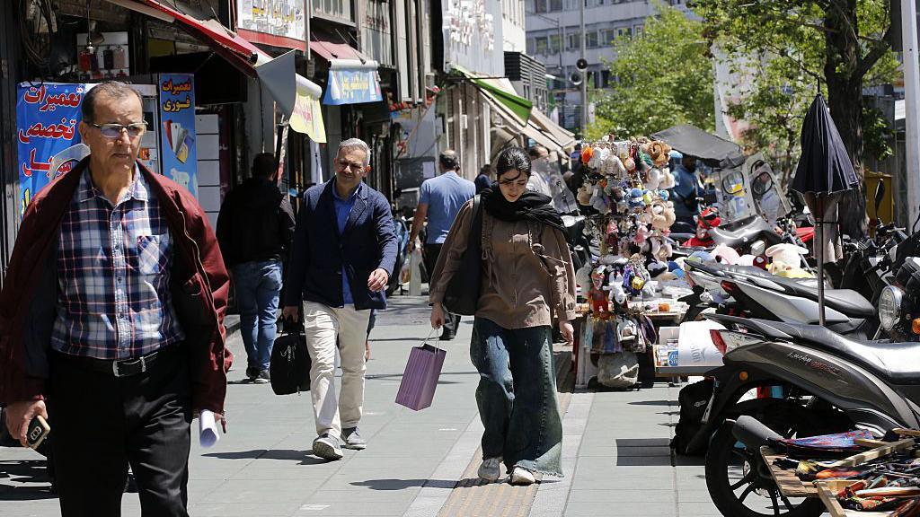 Daily life in Tehran continues - but money is short and risk of war looms