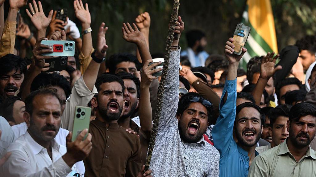 Awami Action Committee (AAC) activists shout slogans during a demonstration in Muzaffarabad, capital of Pakistan-administered Kashmir on October 1, 2025, demanding structural reforms and political and economic rights.