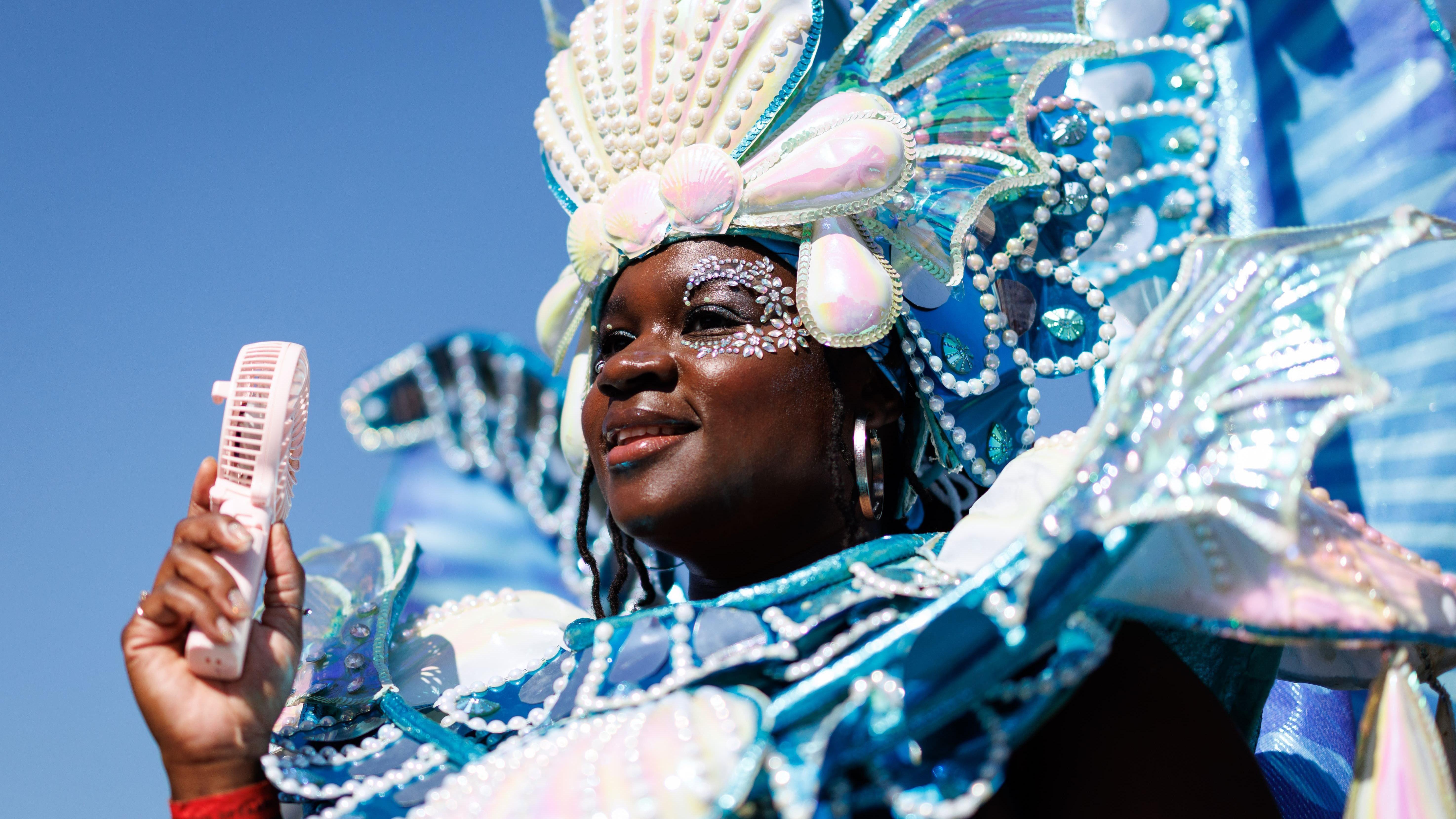 Notting Hill Carnival revellers party in the sunny streets