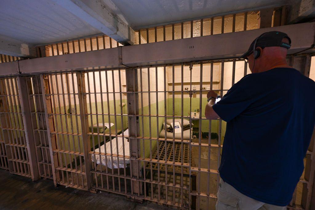 Un hombre hace una foto a una celda de Alcatraz.