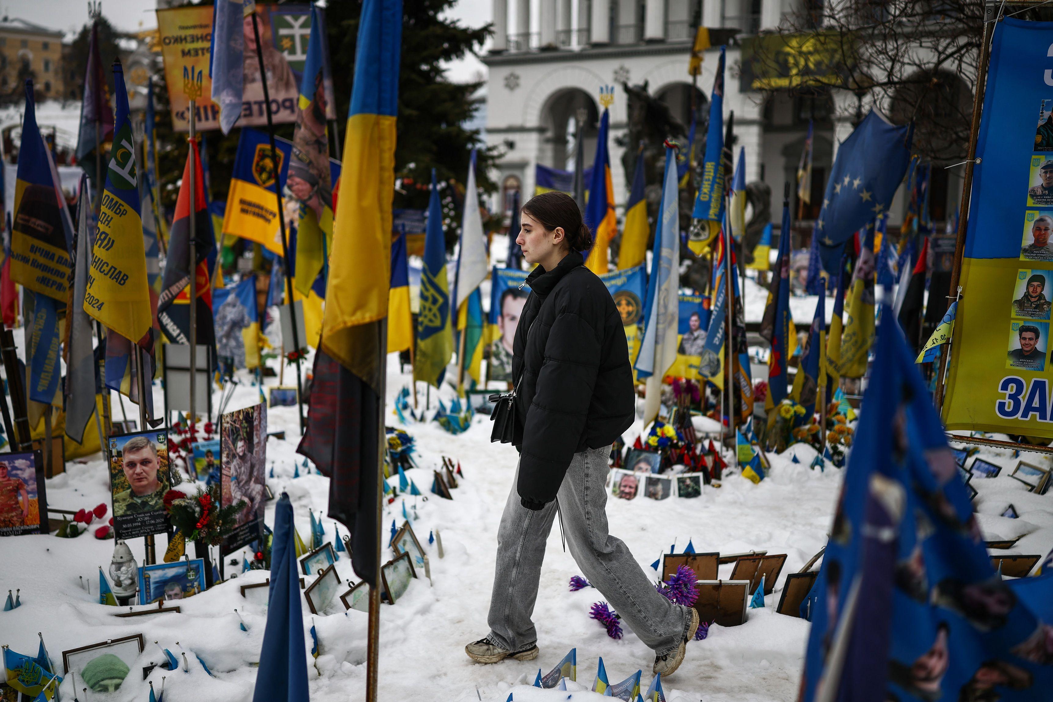 فتاة قرب نصب تذكاري مؤقت لجنود أوكرانيين وأجانب قتلوا في الحرب، بالتزامن مع دخول الصراع مع روسيا عامه الرابع، في كييف في 23 فبراير/شباط 2026 