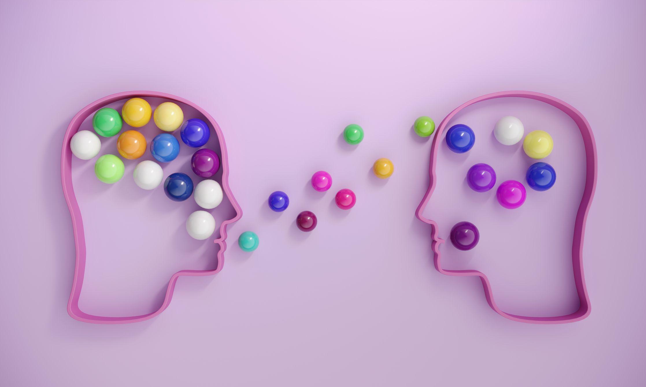 Dos siluetas con forma de cabezas y con pelotas de colores dentro