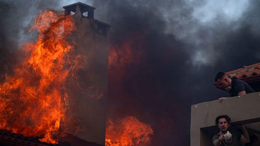 Wildfires rage in Greece as extreme heat persists
