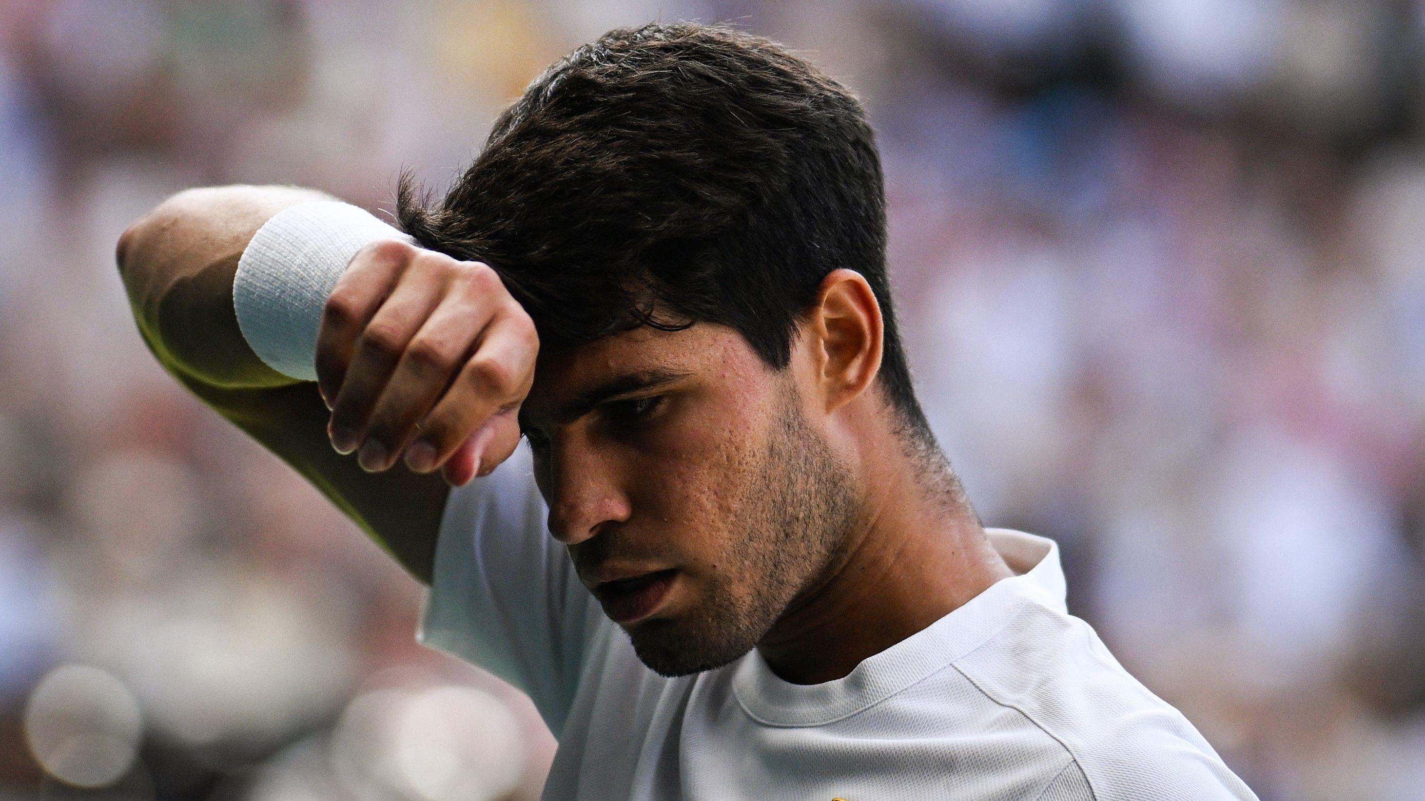 Wimbledon final: Alcaraz saves another break point but still trails Sinner in second set