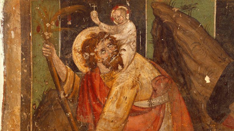 A imagem retrata uma pintura religiosa medieval de S&atilde;o Crist&oacute;v&atilde;o carregando o menino Jesus sobre os ombros enquanto atravessa um rio, uma das representa&ccedil;&otilde;es mais tradicionais do