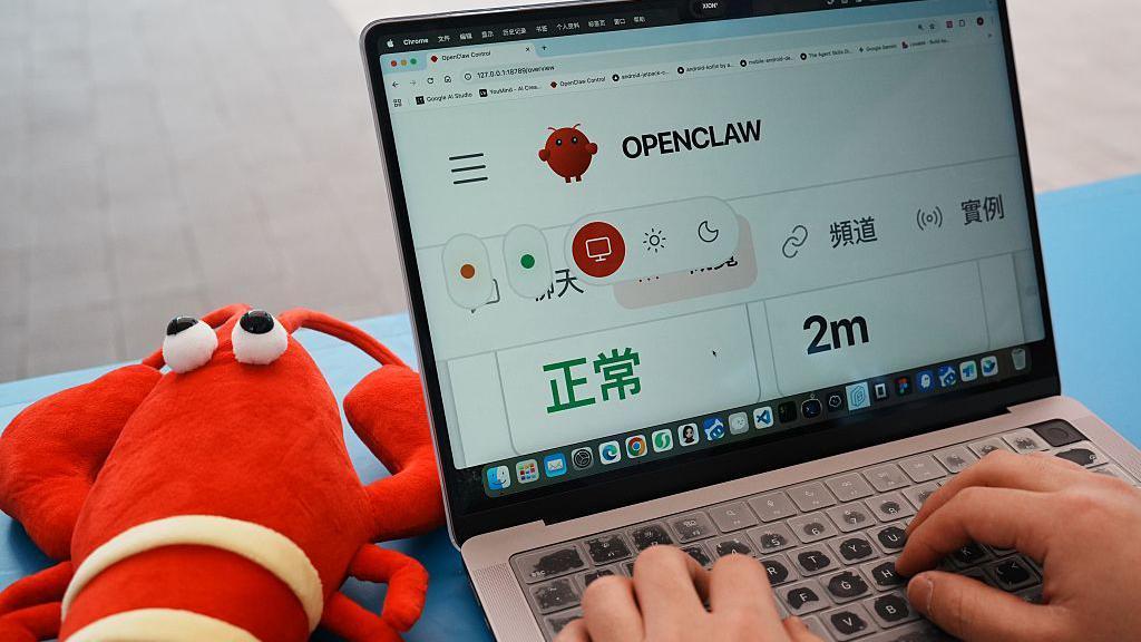左邊是一隻龍蝦玩偶，右邊是一台電腦，上邊顯示Openclaw代理工具。