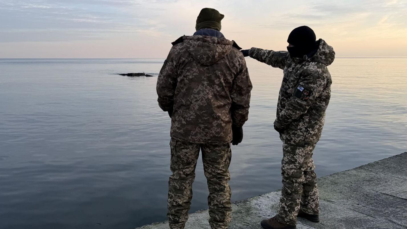 Two Ukrainian Navy soldiers looking out at the Black Sea