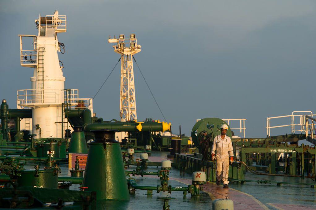 A crew man walks along the deck of oil tanker 'Devon' as it prepares to transport crude oil from Kharg Island to India in Bandar Abbas, Iran, on Friday, March 23, 2018. Geopolitical risk is creeping back into the crude oil market. Photographer: Ali Mohammadi/Bloomberg via Getty Images