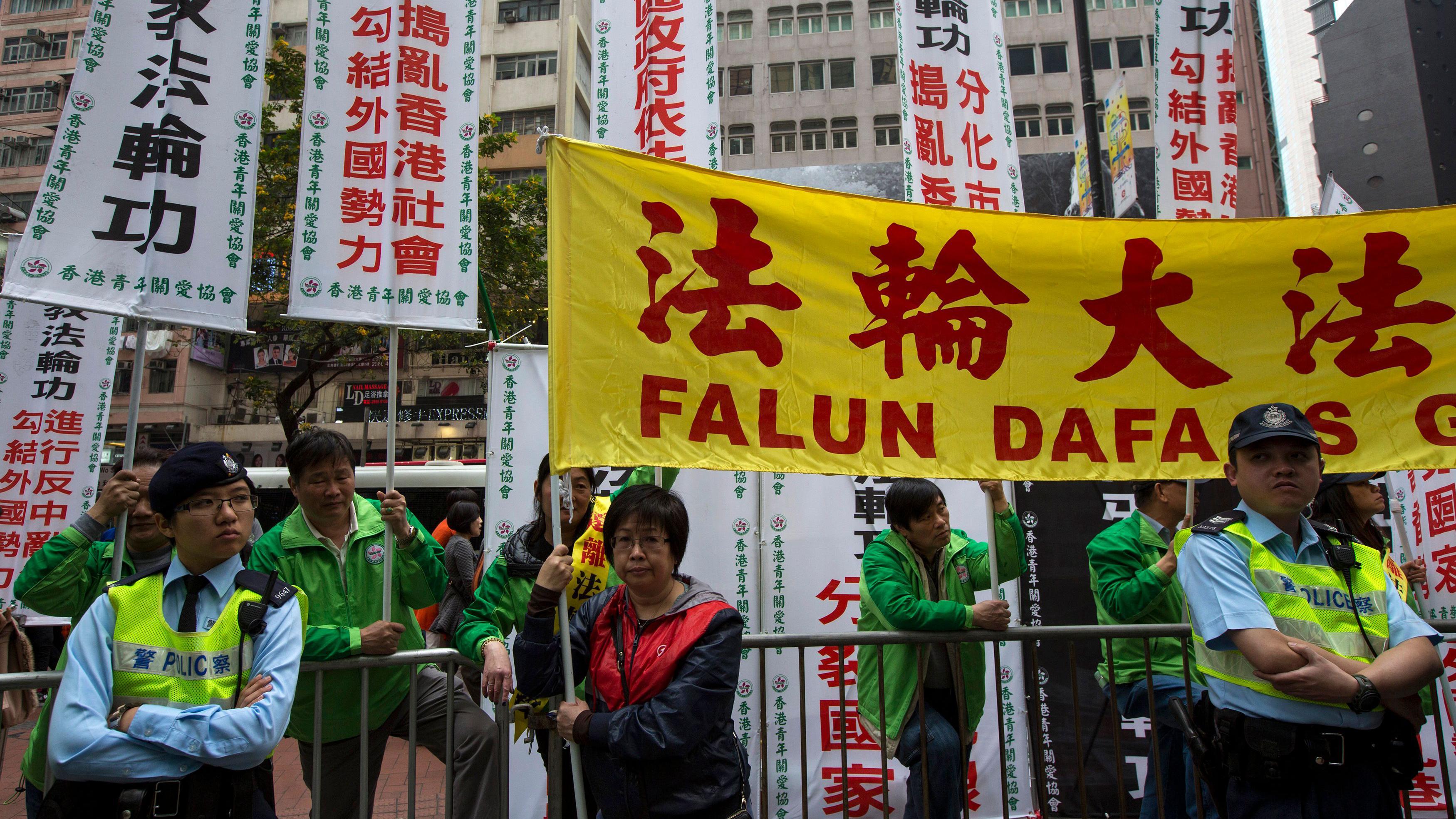 親建制團體與法輪功學員在香港銅鑼灣街頭對峙，警察在旁監視（16/3/2014）