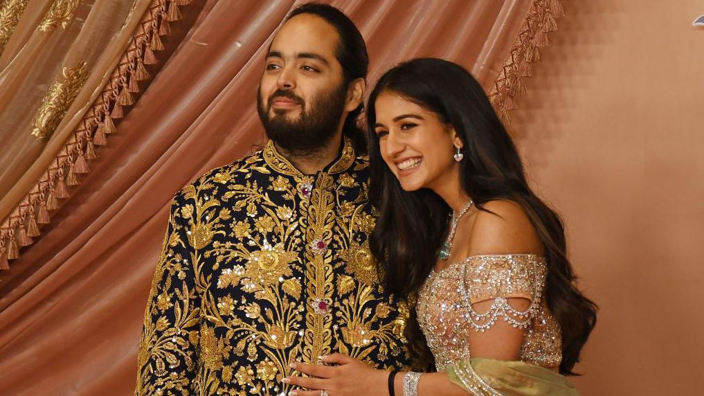 مومباي، ماهاراشترا، الهند- 5 يوليو/تموز 2024: أنانت أمباني (نجل رجل الأعمال الهندي موكيش أمباني) وخطيبته راديكا ميرشانت يلتقطان صورة على السجادة الحمراء خلال حفل السانجيت في مركز جيو العالمي في مومباي. 