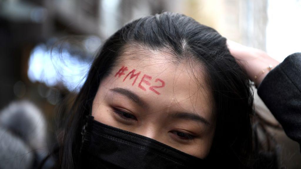 A supporter of Zhou Xiaoxuan, a feminist figure who rose to prominence during Chinas #MeToo movement two years ago, has a #MeToo penned on her forehead in front of the Haidian District Peoples Court in Beijing on December 2, 2020, in a sexual harassment case against one of China's best-known television host