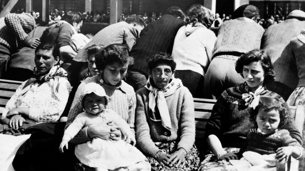 Stanovnici Tristana da Kunje na crno beloj fotografiji sa decom sede tokom evakuacije u Kejp Taun u Južnoafričkoj Republici, a odatle su odvedeni u Veliku Britaniju
