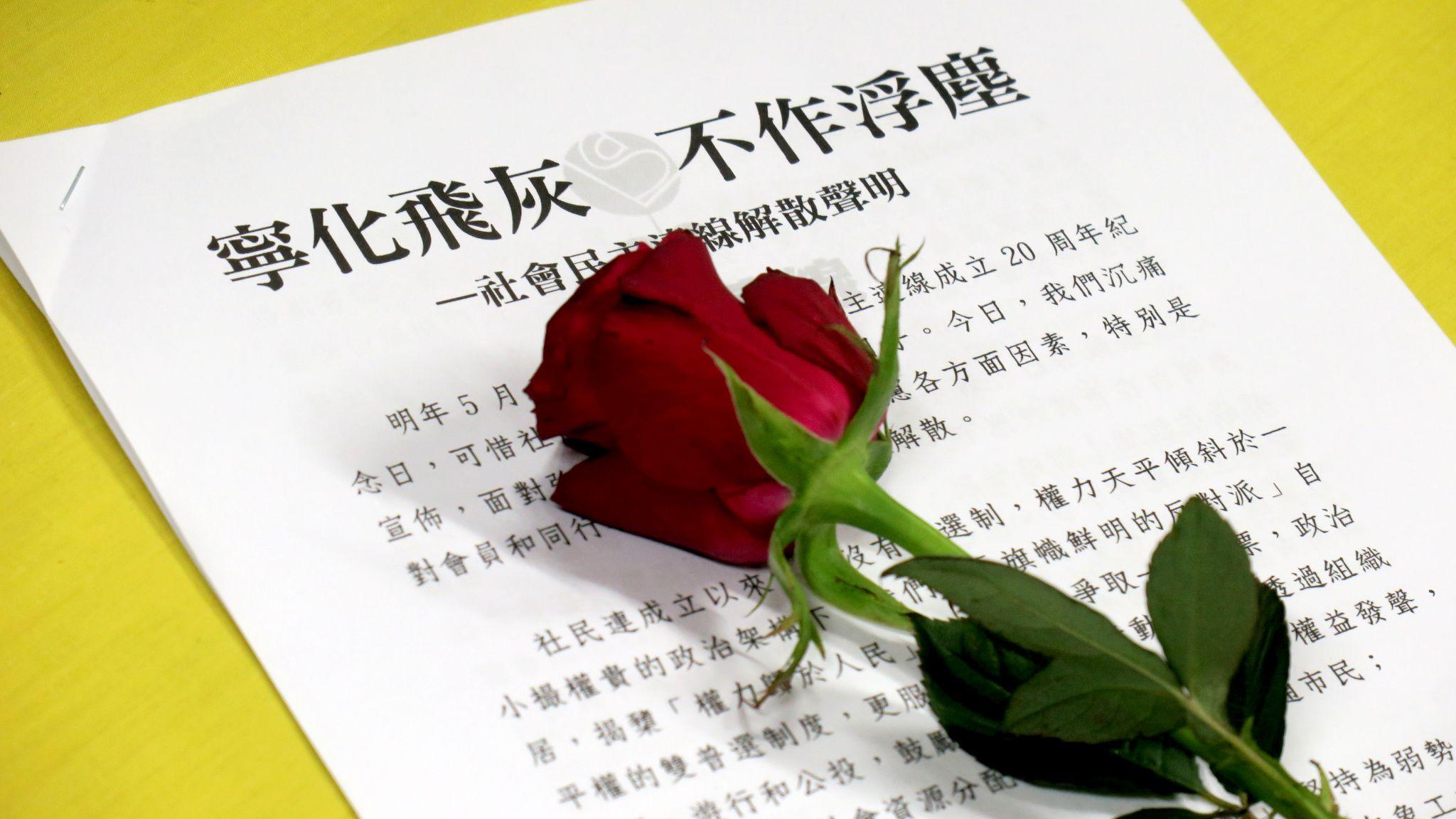 香港社民連解散記者會上展示的一份書面聲明與一朵紅玫瑰（BBC中文圖片29/6/2025）