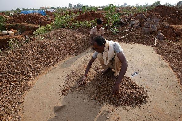 INDIA-LABOUR-MININGIn this photo taken on October 11, 2018, Indian labourers search for diamonds in materials taken from shallow pit mines in Pati village about 15km from Panna in Madhya Pradesh state. An Indian labourer in the diamond mining area of Panna found a 42-carat diamond estimated to be worth around 15,000,000 rupees (200,000 USD) on October 9, India media reported. The district in Madhya Pradesh's Bundelkhand region hosts shallow pit mines that are offered on lease to diggers who seek the precious stones.
