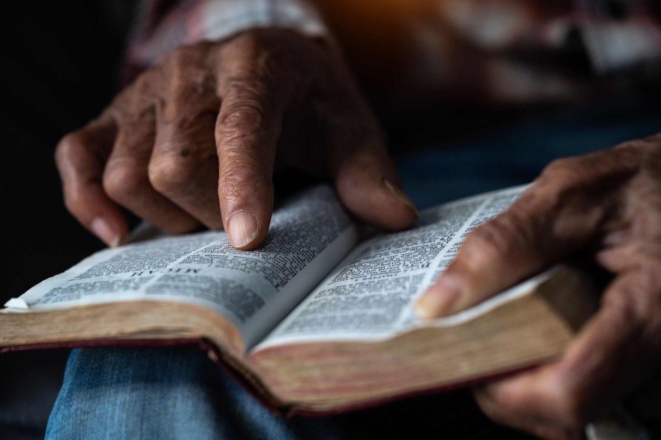 La manos de una persona de color sobre una Biblia