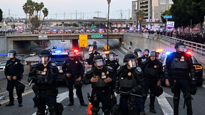 LA police enforce curfew as Trump vows to 'liberate' city