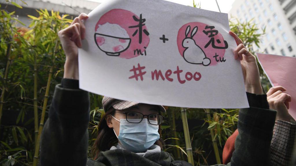 Supporters of Zhou Xiaoxuan, a feminist figure who rose to prominence during Chinas #MeToo movement two years ago, display posters outside the Haidian District Peoples Court in Beijing on December 2, 2020, in a sexual harassment case against one of China's best-known television hosts. 