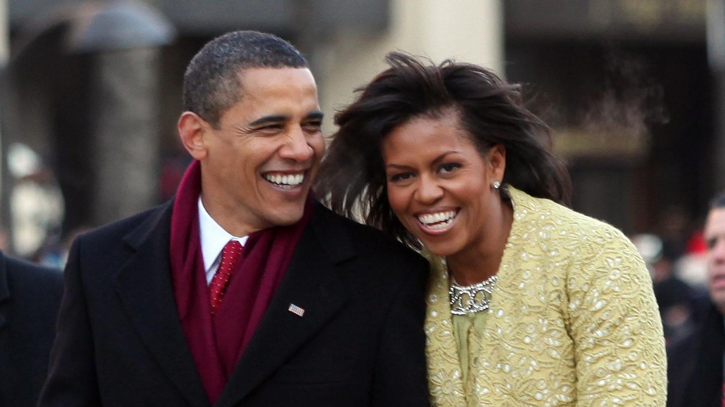 President Barack Obama and first lady Michelle Obama smile as they walk in the inaugural parade following his inauguration as the 44th President of the United States of America on 20 January 2009
