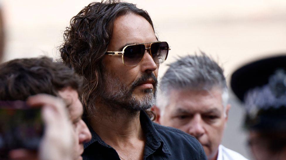 Russell Brand arrives at court for first hearing
