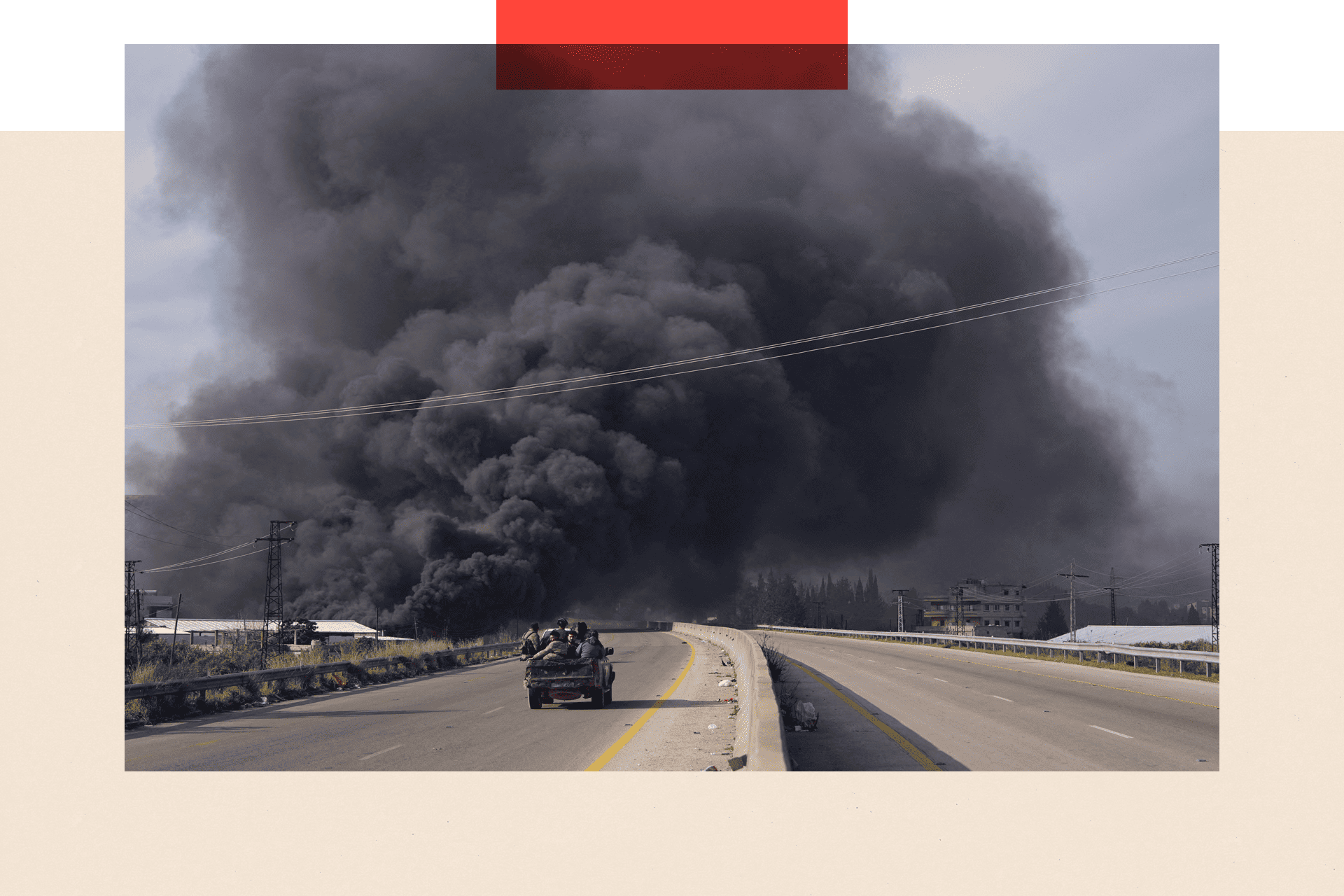 A massive cloud of black smoke behind a car
