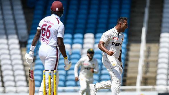 Mohammad Ali (R) of Pakistan celebrates the dismissal of Justin Greaves (L) of West Indies during the 2nd day of 1st Test match between West Indies and Pakistan at Brian Lara Cricket Academy in Tarouba